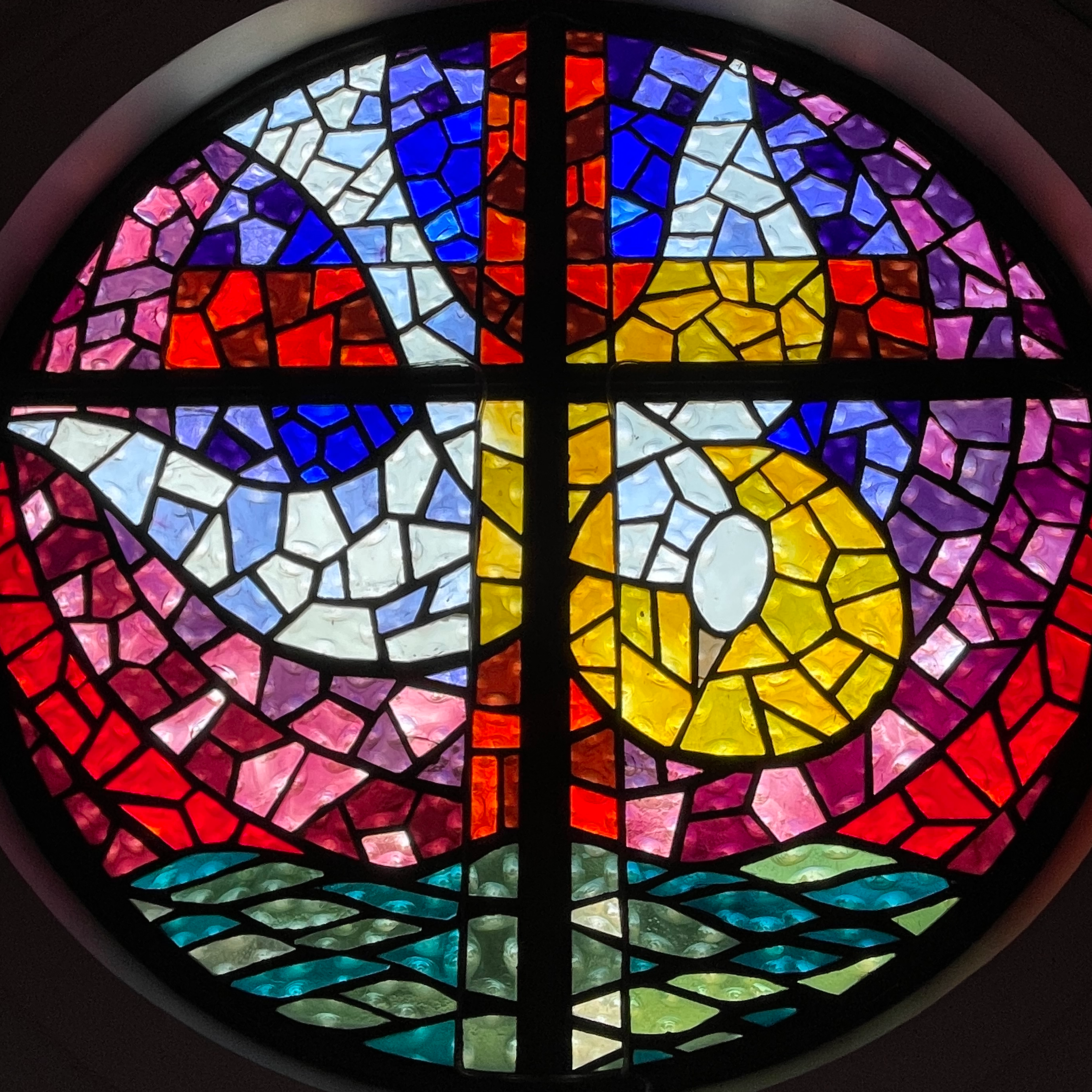 The stained-glass dove window in the worship center